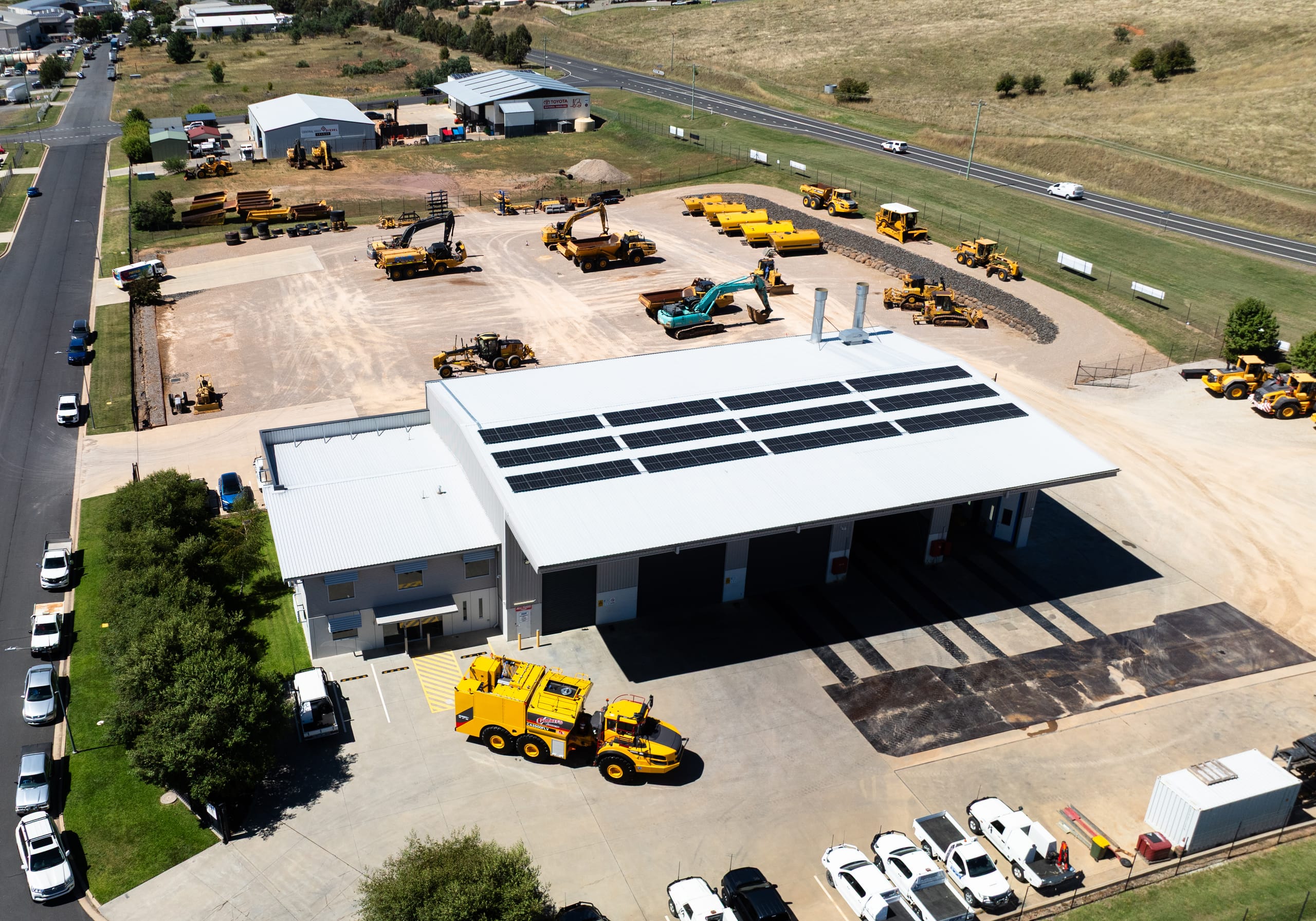 Aerial view of Coleman's Equipment yard, workshop buildings, roads, and machinery