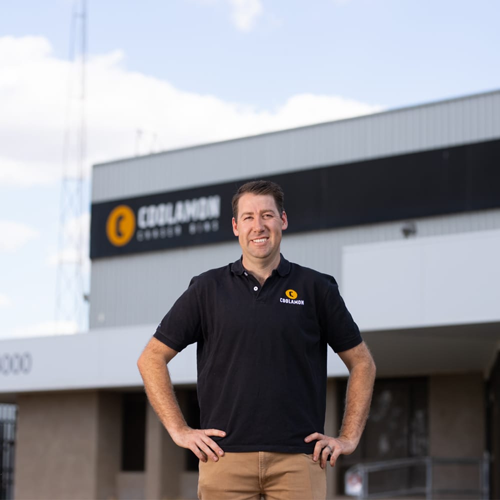 Coolamon staff member standing outside a Coolamon Mother Bins factory building