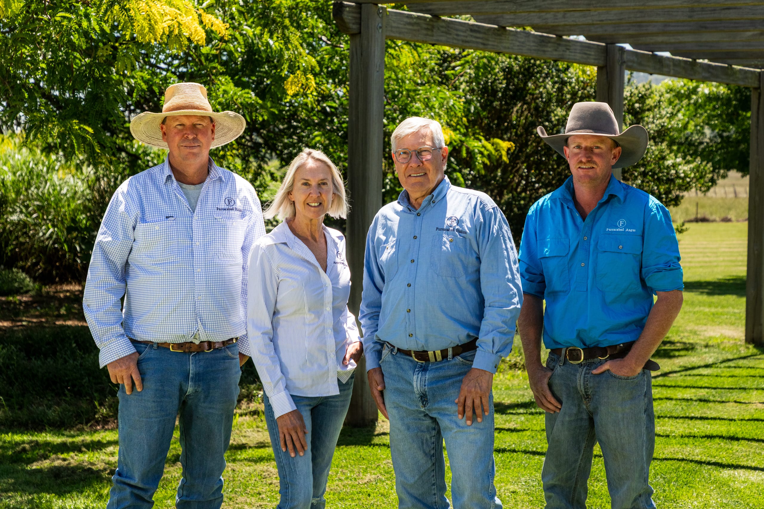 Four Furracabad Angus team members standing together in the shade