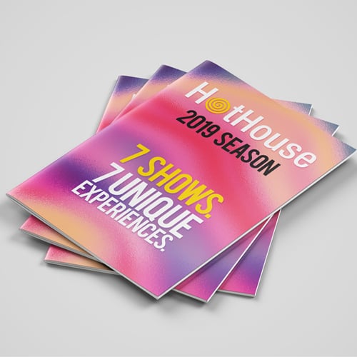 Stack of colorful Hothouse 2019 season brochures reading 7 shows 7 unique experiences