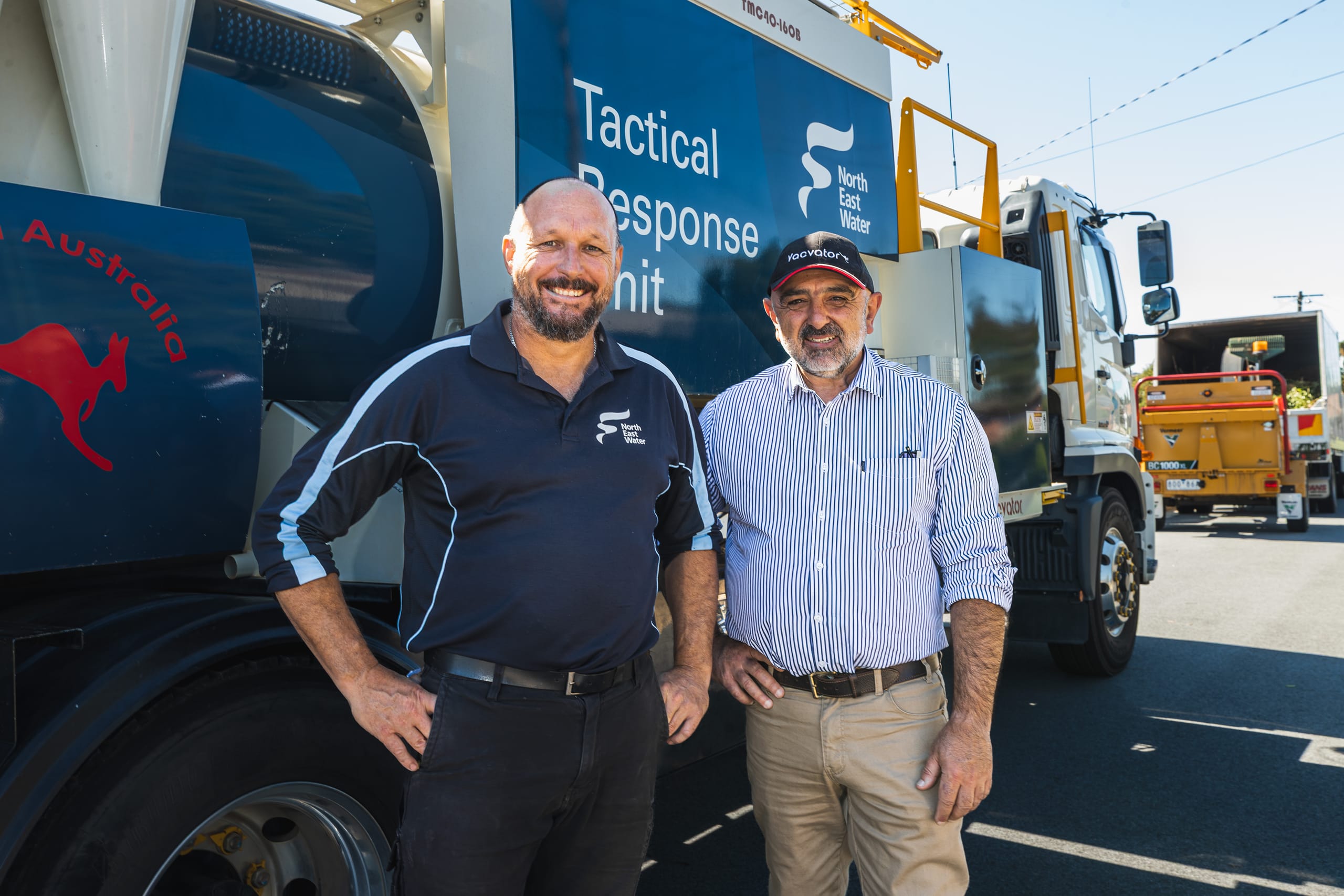 Two Vacvator team members standing beside a tactical response vacuum truck