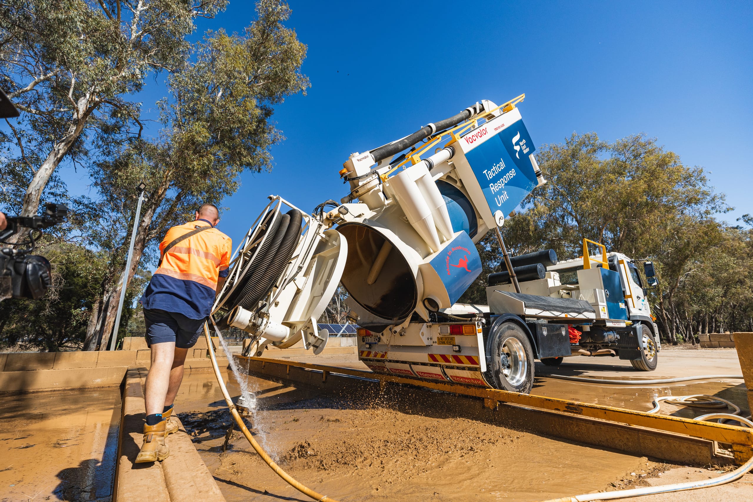 Vacvator vacuum truck operating at a hydro excavation worksite with hoses extended