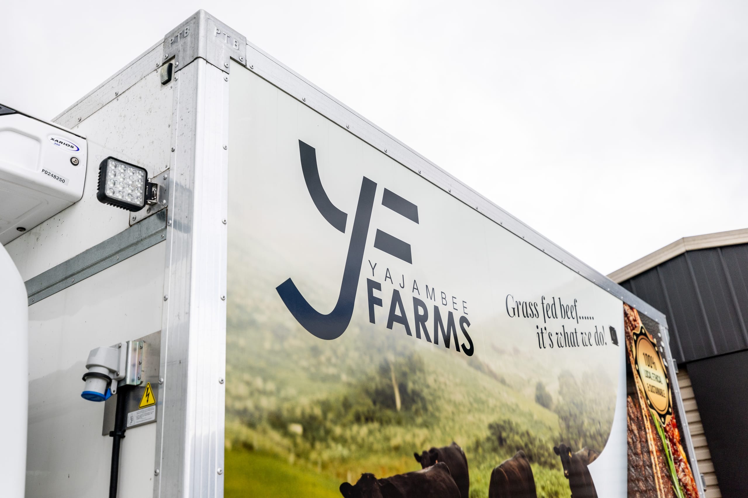 Close-up of a Yajambee Farms branded refrigerated delivery truck